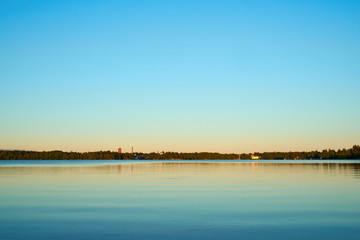 Peaceful sunset on lake with pastel colors. Natural background. 