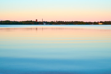 Peaceful sunset on lake with pastel colors. Natural background. 