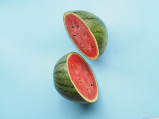 Minimal concept, watermelon sliced isolated on pastel blue background . Flat lay top view.