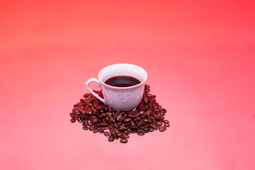 White cup with coffee and coffee beans. Pink tinting
