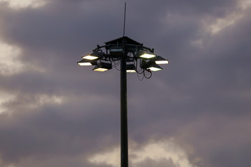 Lanterns on a pole against the sunset