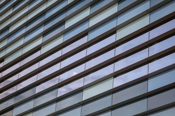 Glass building walls in the rays of sunset as background