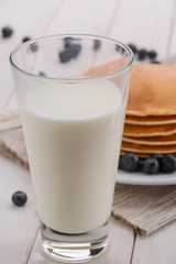 Milk and pancakes with blueberries