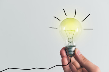 Bulb in hand, concept of idea