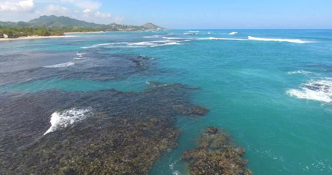 Untouched beauty. Aerial shot of beautiful ocean waves and coral reef. Exotic beauty of nature. 4k