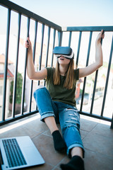 Beautiful young woman enjoying virtual reality at her home.