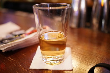 A nearly finished glass of beer