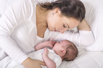Obraz na płótnie Canvas Gentle mama lying near dormant kid