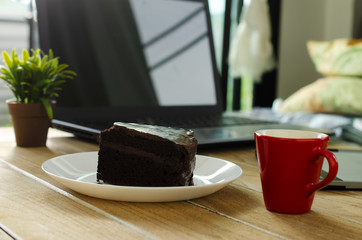 Delicious chocalate cake dessert and hot coffee drink for life style technology concept backgrounds