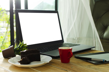 Life style technology concept with Red coffee cups and Chocolate cake, Laptop computer white screen for your content