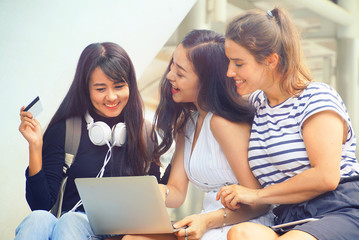 Three women sitting together and feel happy with shopping online
