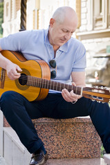 Fototapeta premium A street musician plays the guitar