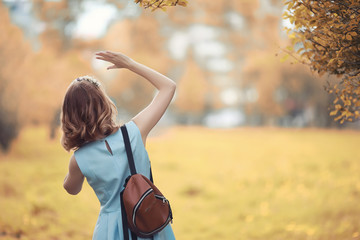 Young girl on a walk in the autumn 