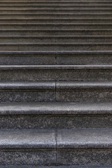 Ausschnitt einer Treppe aus Granitsein mit vielen Stufen als Hintergrund, Section of a granite staircase with many steps as background