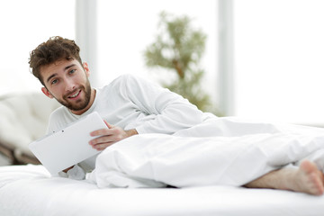 closeup.awakened man with digital tablet