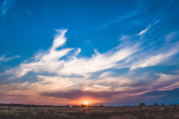 Fototapeta premium Beautiful sunset over the city. Multicolored sky. Clouds. The sun.