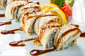 Various kinds of sushi served on black stone