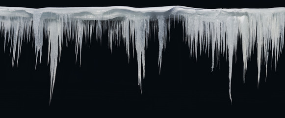 Icicles on an black background, isolated object. - obrazy, fototapety, plakaty