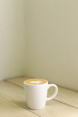 Hot coffee latte isolated on wooden table
