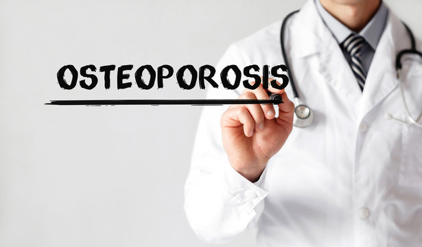 Doctor writing word Osteoporosis with marker, Medical concept