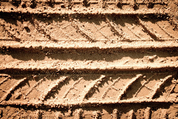 Tyre tracks texture on sand in brown tone
