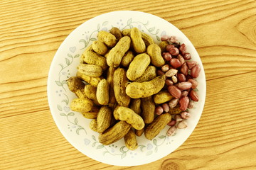 boiled or steamed home maid salty Peanuts snack in plate Isolated on wooden Background top view