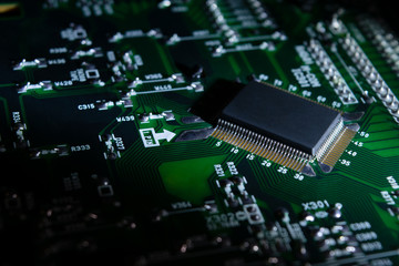 Fototapeta premium part of an electronic circuit board with a microcircuit and electronic components.