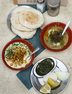 Hummus and Ful plates at market, Tel Aviv, Israel.