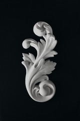 White stucco acanthus  leaf on a black background.