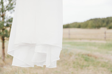 Detail of wedding dress blowing in a light breeze.