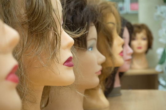 Wigs on the heads of mannequins
