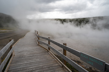Boardwalk through steam from a thermal feature in Yellowstone National Park along Firehole Drive