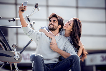 Smiling young couple in love taking selfie