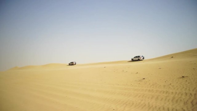 Desert Safari SUVs bashing through the arabian sand dunes. SUV tour through the Arabian desert