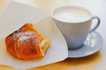 Croissant and a cup of cappuccino