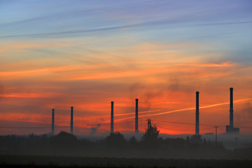 Fototapeta na wymiar Smoke-screen factory chimneys at sunrise 