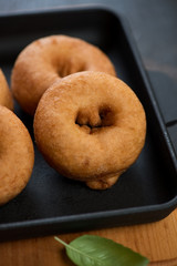 Close-up of freshly cooked donuts in a cast-iron pan, selective focus