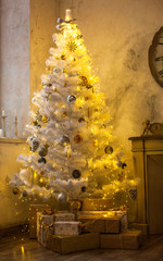 Interior of the new year. White Christmas tree, fireplace, chair and clock