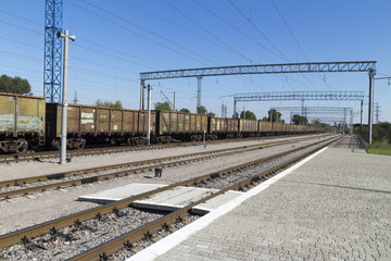 Fototapeta na wymiar Old rusty freight train on the new platform