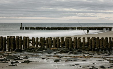 Fishing on the North Sea beach.