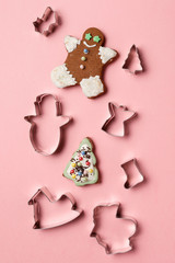 Christmas cookies various shape cutter on pink background. Top view. Flat lay. Trendy colorful photo. Minimal style with colorful paper backdrop. Christmas concept.
