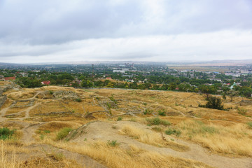 Top view of the city of Kerch and the ruins of the ancient Greek city of Panticapaeum on mount Mithridates on a cloudy autumn day