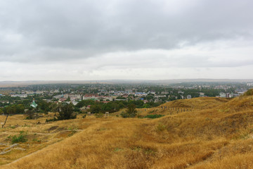 Fototapeta na wymiar Top view of the city of Kerch and the ruins of the ancient Greek Panticapaeum on mount Mithridates on a cloudy autumn day