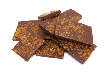 Chocolate with caramel and salt pieces isolated on white background