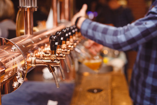 A Lot Of Beer Taps In A Close-up Bar