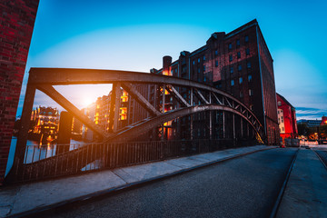 Poggenmuehlen Bridge at dawn. Hamburg, Germany. illuminated buildings and last sunrays. Warehouse District Speicherstadt Landmark of HafenCity quarter. Most visited touristic famous place