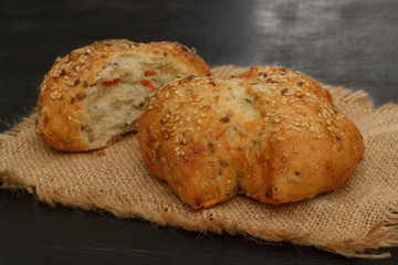 bun with sesame and carrots on linen cloth