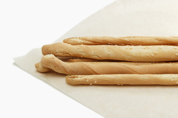 Bread sticks on paper. White background