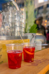 Two plastic glasses of Aperol Spritz cocktails on the table in outdoor bar in Venice, Italy.