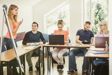 Students and teacher tutor in classroom